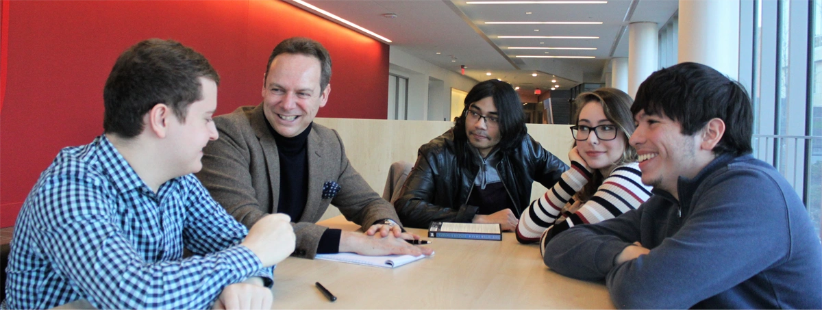 Professor and student discussion at a table